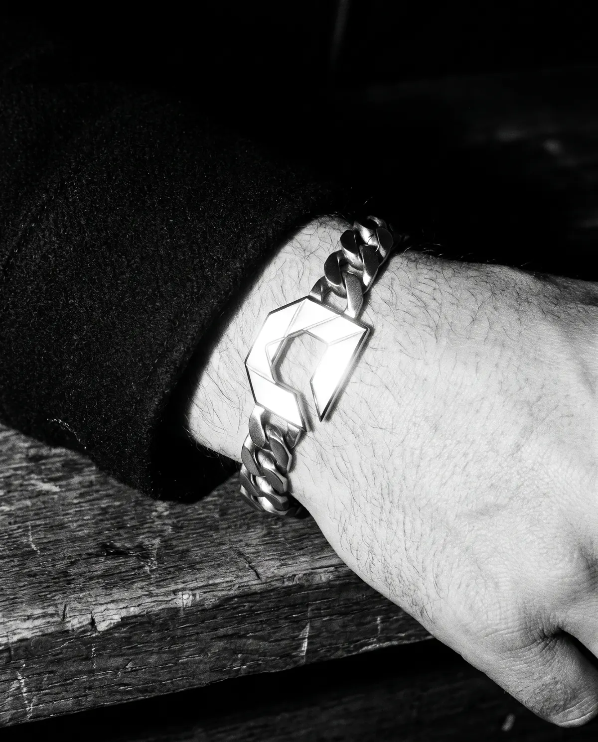 Close up of the chain bracelet: the clasp tag, in stainless steel.