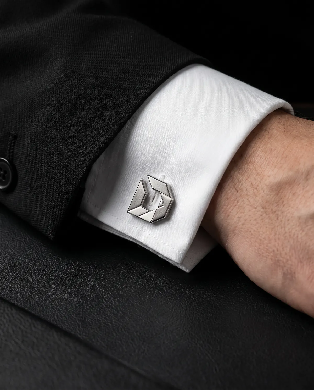Close up of the faceted cufflinks: french cuffs, in stainless steel.