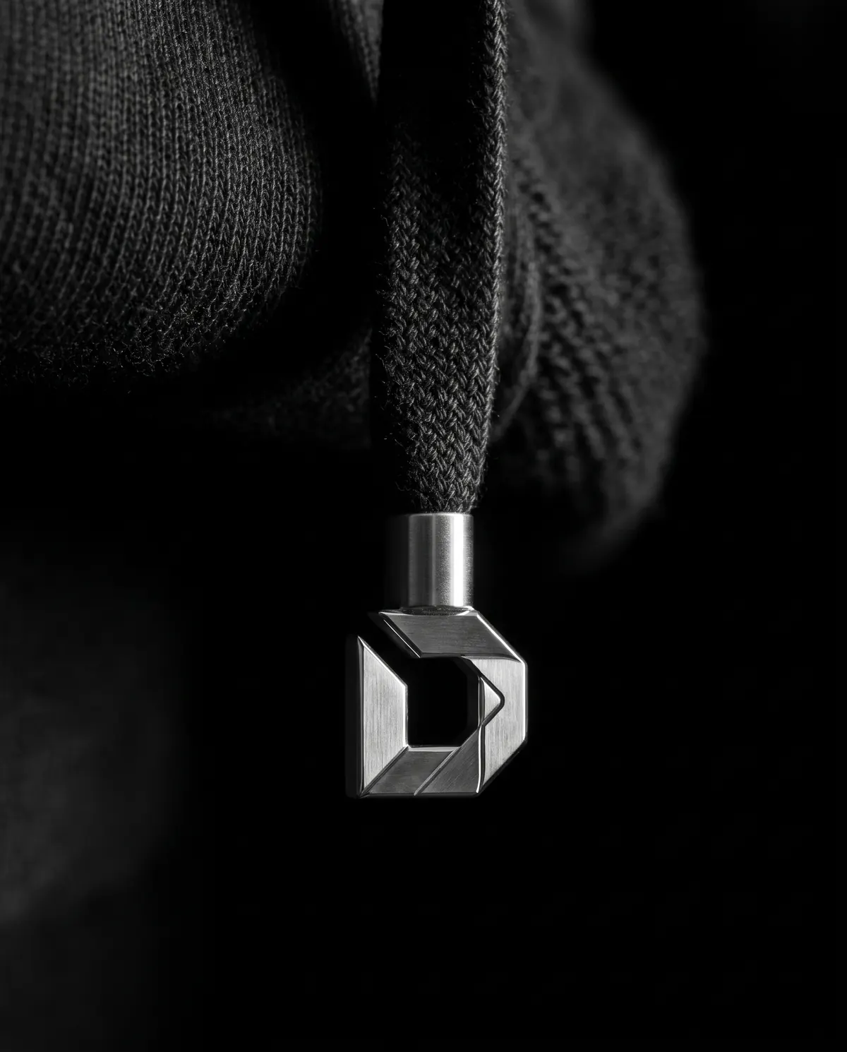 Close up of the heavyweight hoodie: the drawcord tips, in stainless steel.