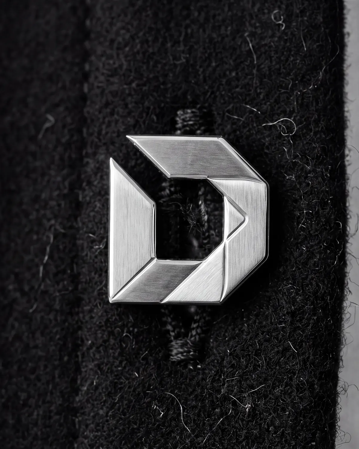 Close up of the melton overshirt: six buttons, front placket, in stainless steel.